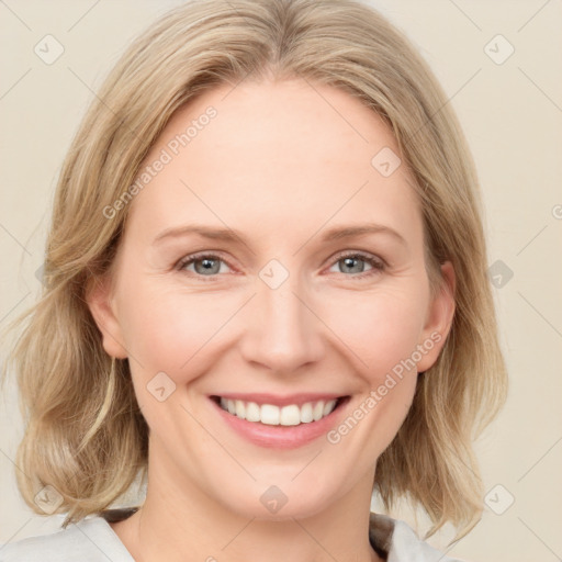 Joyful white adult female with medium  brown hair and blue eyes