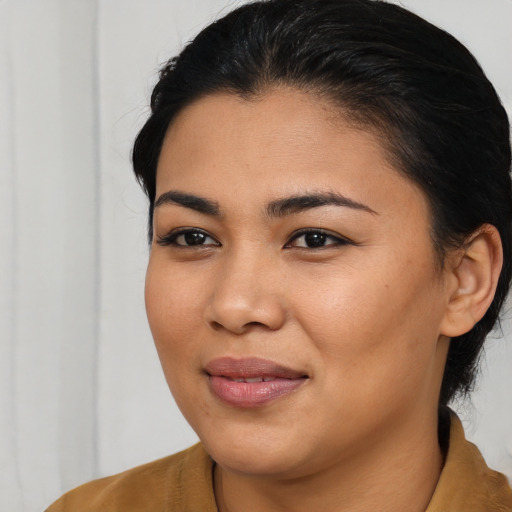 Joyful asian young-adult female with medium  brown hair and brown eyes