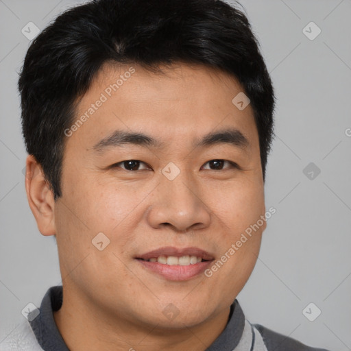 Joyful asian young-adult male with short  brown hair and brown eyes