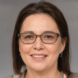 Joyful white adult female with medium  brown hair and grey eyes