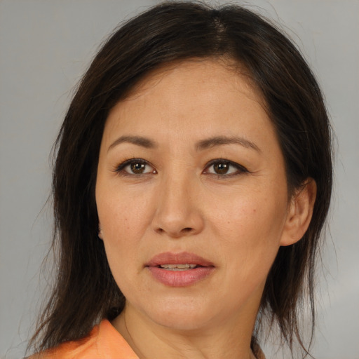 Joyful asian adult female with medium  brown hair and brown eyes