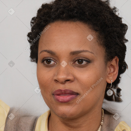 Joyful black adult female with short  brown hair and brown eyes