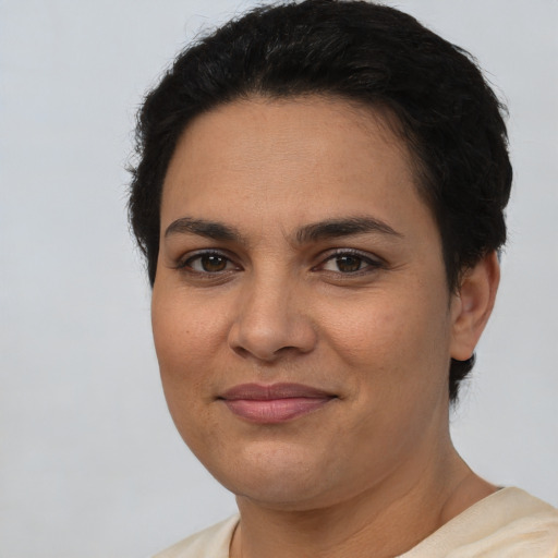 Joyful latino young-adult female with short  brown hair and brown eyes