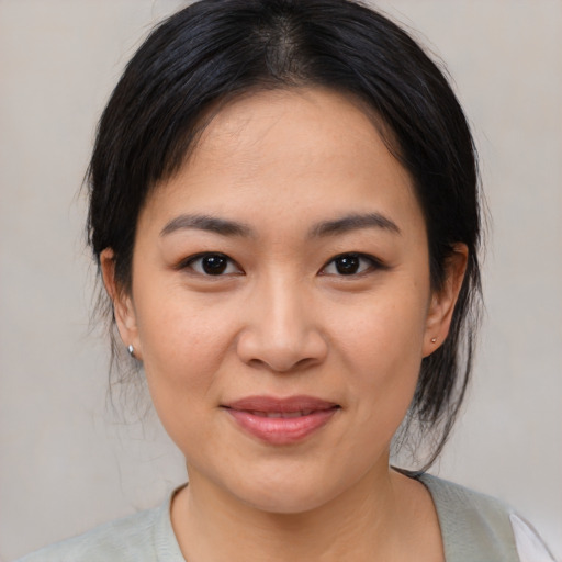 Joyful asian young-adult female with medium  brown hair and brown eyes