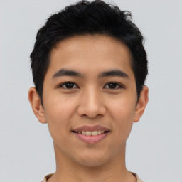 Joyful asian young-adult male with short  black hair and brown eyes