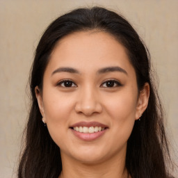 Joyful latino young-adult female with long  brown hair and brown eyes