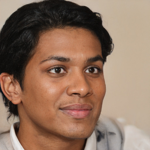 Joyful asian young-adult male with short  brown hair and brown eyes