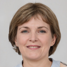 Joyful white adult female with medium  brown hair and grey eyes