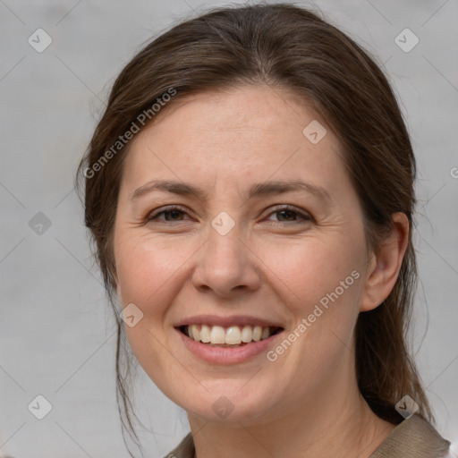 Joyful white adult female with medium  brown hair and grey eyes