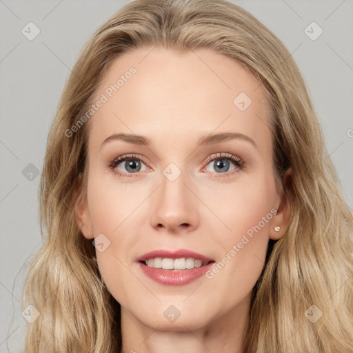 Joyful white young-adult female with long  brown hair and blue eyes