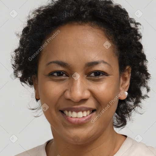 Joyful black adult female with short  brown hair and brown eyes