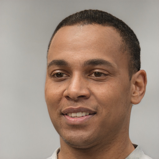Joyful white young-adult male with short  black hair and brown eyes