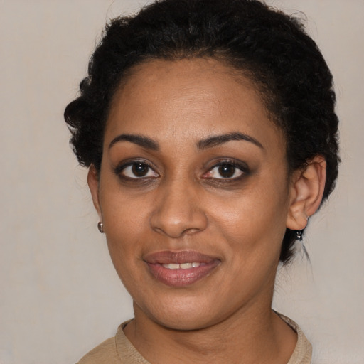 Joyful black young-adult female with short  brown hair and brown eyes