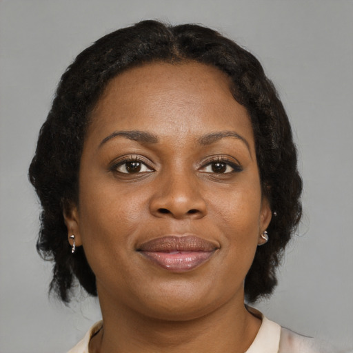 Joyful black young-adult female with medium  brown hair and brown eyes