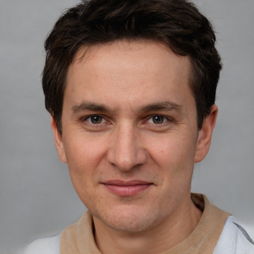 Joyful white adult male with short  brown hair and brown eyes