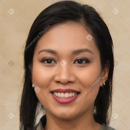 Joyful latino young-adult female with long  brown hair and brown eyes