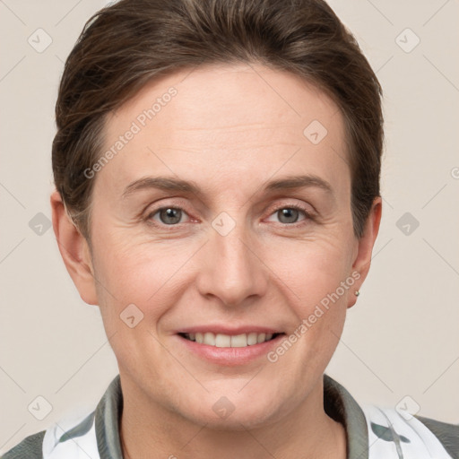 Joyful white adult female with short  brown hair and grey eyes