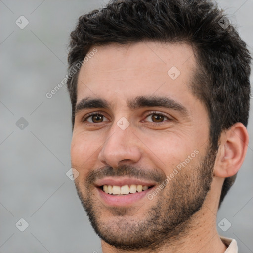 Joyful white young-adult male with short  black hair and brown eyes