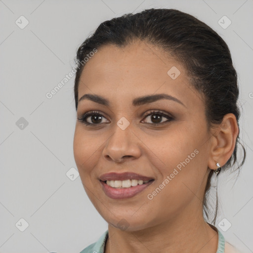 Joyful latino young-adult female with medium  brown hair and brown eyes