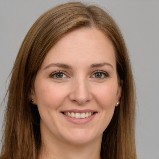 Joyful white young-adult female with long  brown hair and green eyes