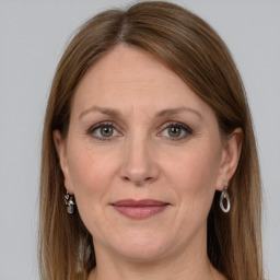 Joyful white adult female with long  brown hair and grey eyes