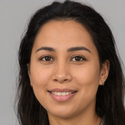 Joyful latino young-adult female with long  brown hair and brown eyes