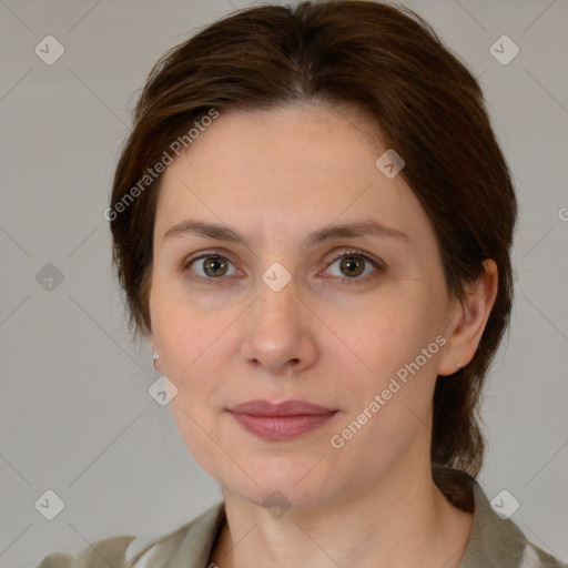 Joyful white adult female with medium  brown hair and green eyes