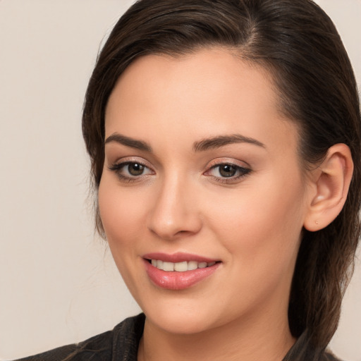 Joyful white young-adult female with long  brown hair and brown eyes