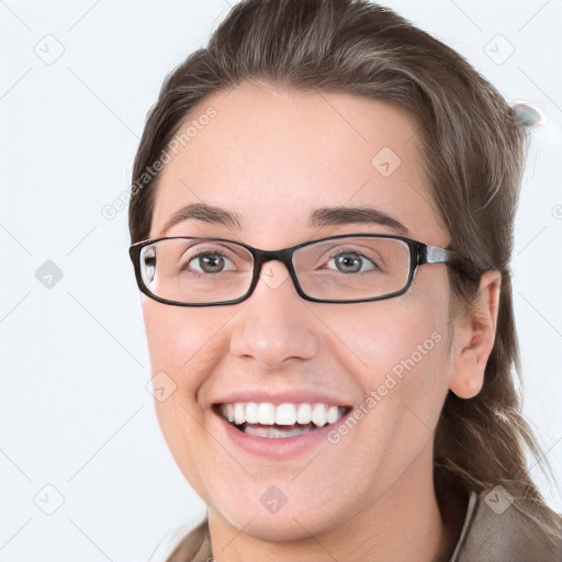 Joyful white young-adult female with medium  brown hair and blue eyes