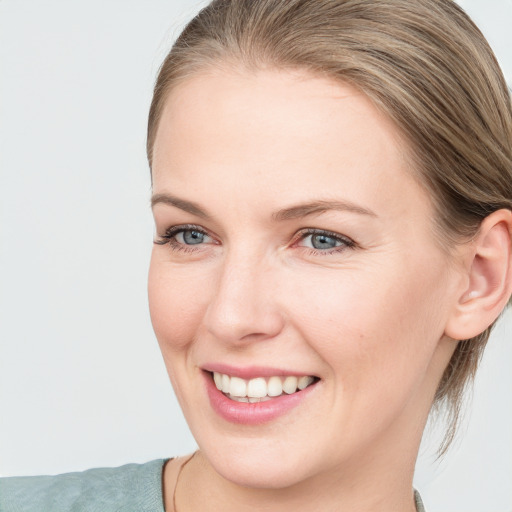 Joyful white young-adult female with medium  brown hair and blue eyes