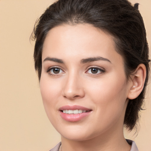 Joyful white young-adult female with medium  brown hair and brown eyes