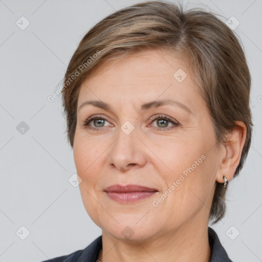 Joyful white adult female with medium  brown hair and brown eyes