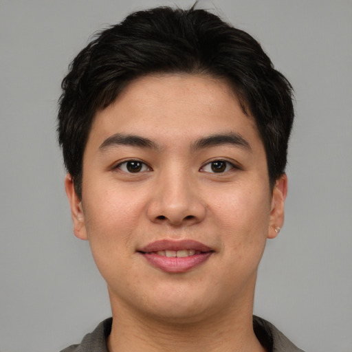 Joyful asian young-adult male with short  brown hair and brown eyes
