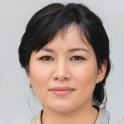 Joyful asian young-adult female with medium  black hair and brown eyes