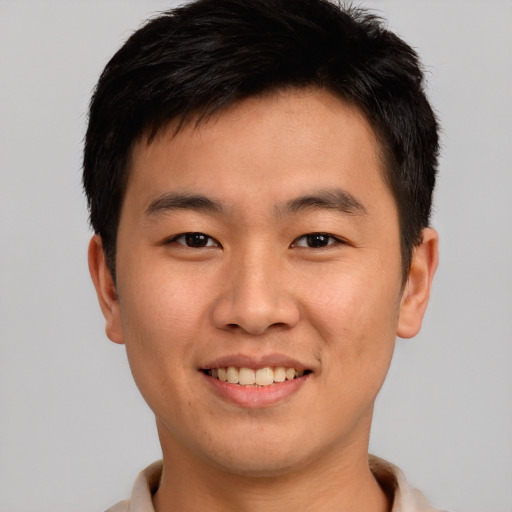 Joyful asian young-adult male with short  brown hair and brown eyes