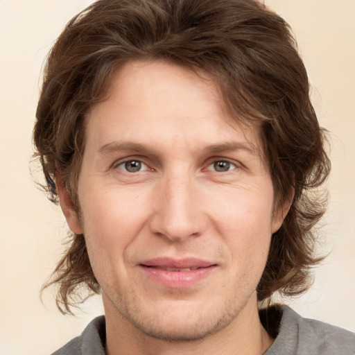 Joyful white adult male with short  brown hair and grey eyes