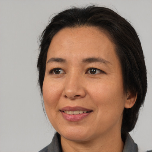 Joyful asian adult female with medium  brown hair and brown eyes
