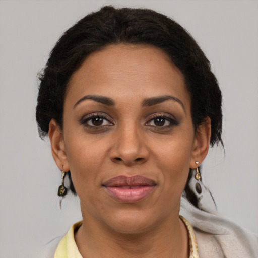 Joyful latino adult female with medium  brown hair and brown eyes