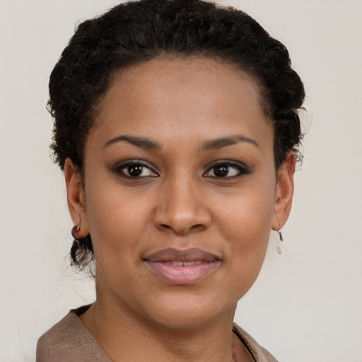 Joyful black young-adult female with short  brown hair and brown eyes