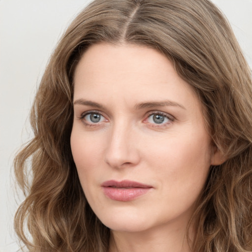 Joyful white young-adult female with long  brown hair and green eyes