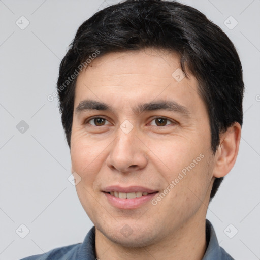 Joyful white adult male with short  brown hair and brown eyes