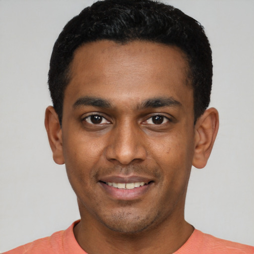 Joyful latino young-adult male with short  black hair and brown eyes