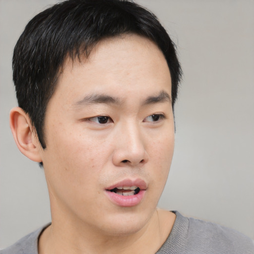 Neutral asian young-adult male with short  brown hair and brown eyes