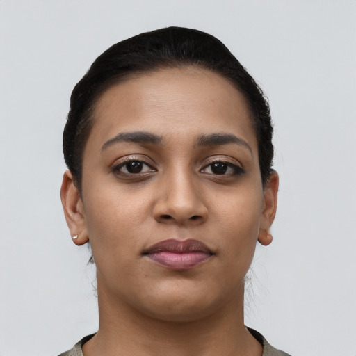 Joyful latino young-adult female with short  black hair and brown eyes