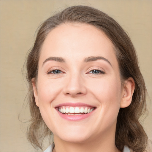 Joyful white young-adult female with medium  brown hair and grey eyes