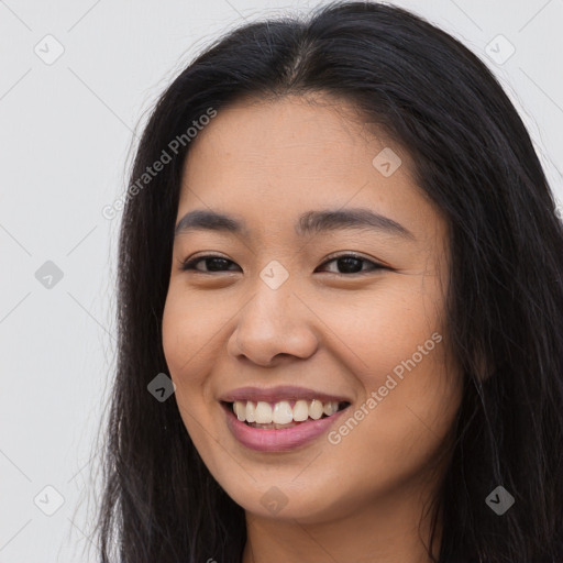 Joyful asian young-adult female with long  brown hair and brown eyes