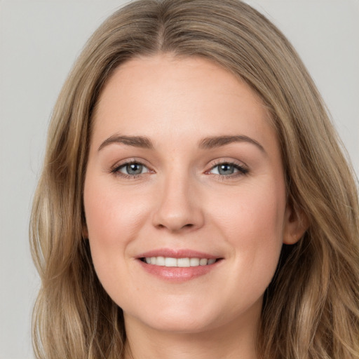 Joyful white young-adult female with long  brown hair and grey eyes