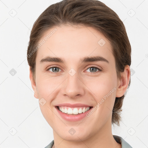 Joyful white young-adult female with medium  brown hair and grey eyes