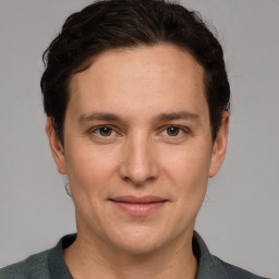 Joyful white adult male with short  brown hair and grey eyes