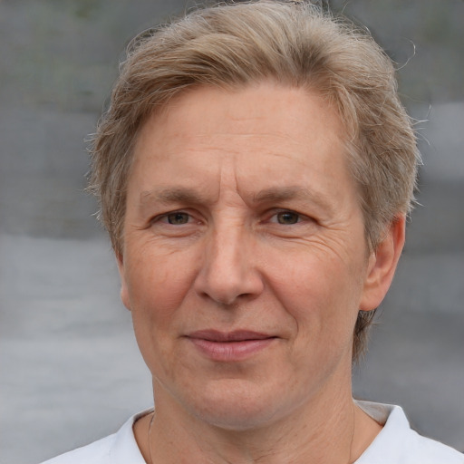 Joyful white middle-aged male with short  brown hair and grey eyes